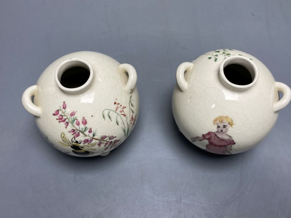 A pair of globular earthenware posy vases, height 10cm